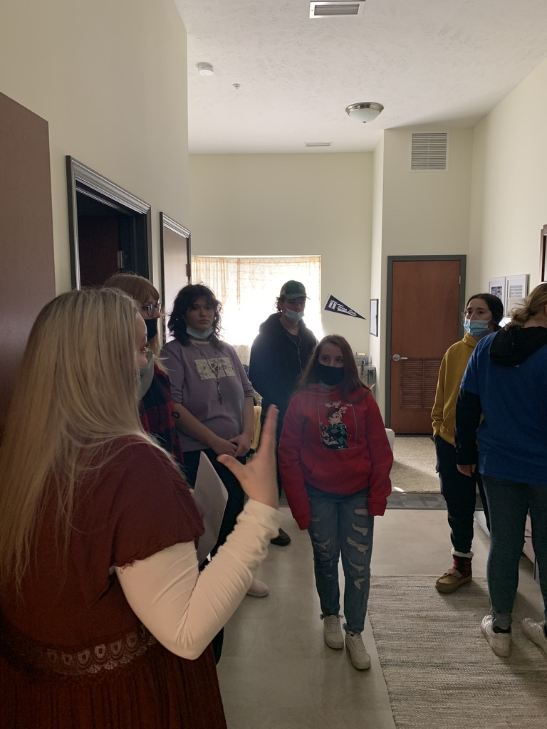 Students viewing a college dorm room 